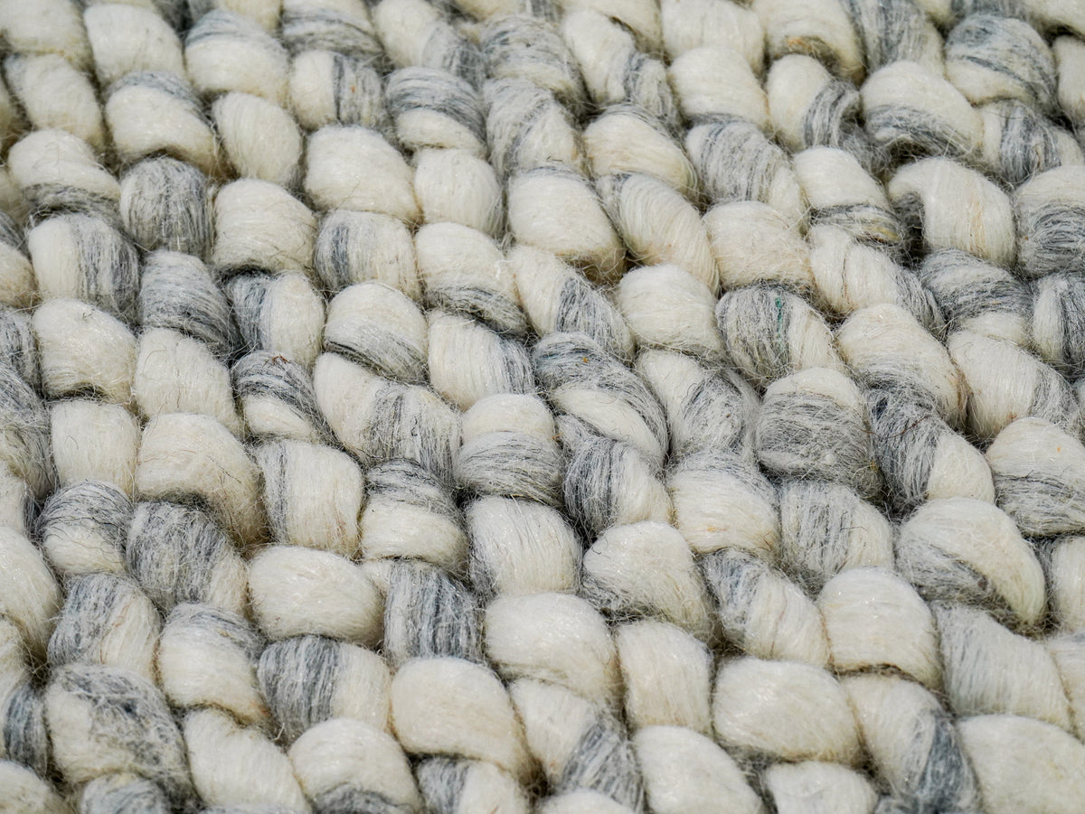 Cashew Loop — Wool rug in a tight surface detail showing gray marling through ivory loops