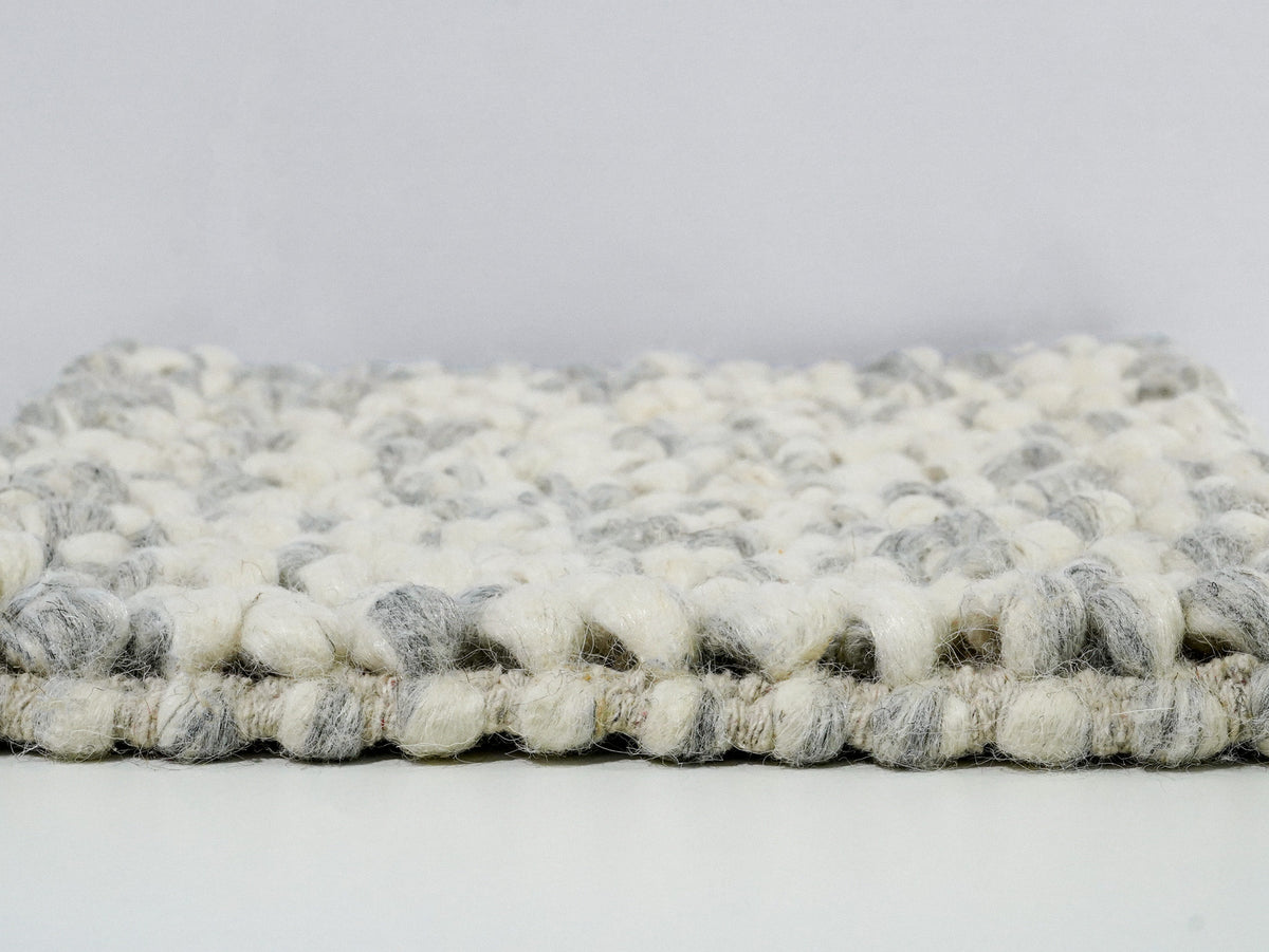Gray Cashew Loop — Wool rug shown from the side to reveal the loop pile profile