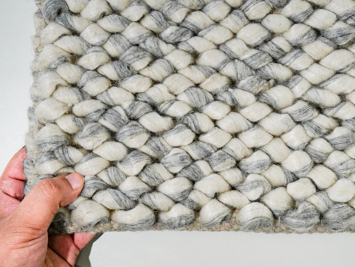 Gray Cashew Loop — Wool rug styled in a living room, highlighting its chunky loop texture