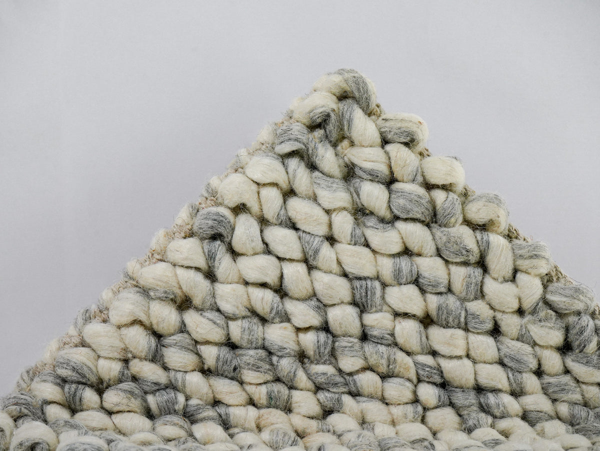 Gray Cashew Loop — Wool rug with a lifted corner displaying the loop pattern