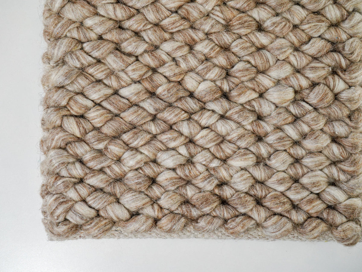 Cashew Loop — Wool rug, lower-left edge showing beige and tan yarn variation