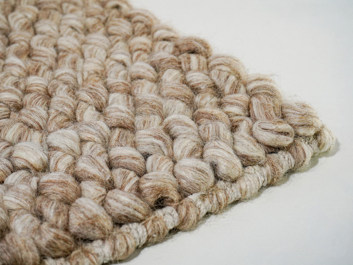 Beige Cashew Loop — Wool rug, low angled view of the raised loops and wrapped edge