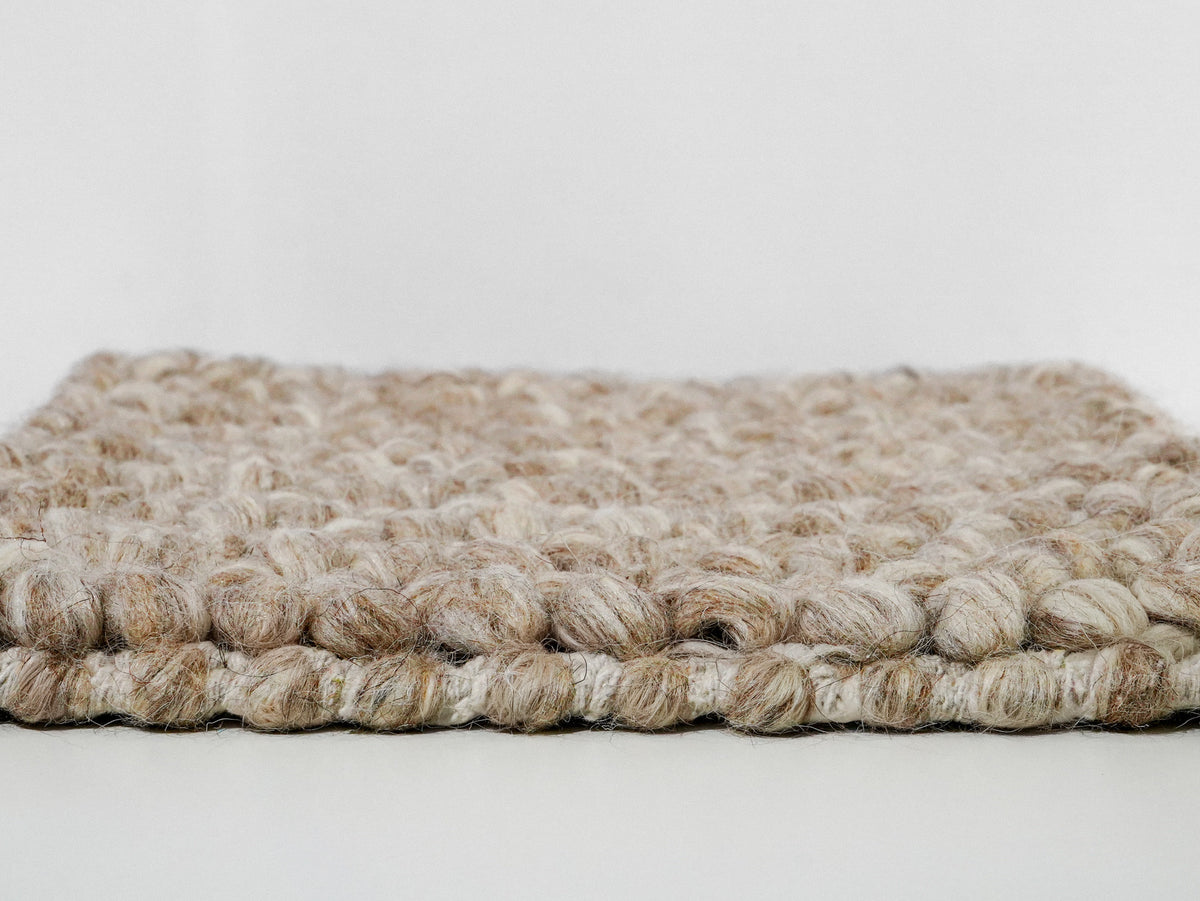 Beige Cashew Loop — Wool rug, side profile showing the loop surface above the finished base