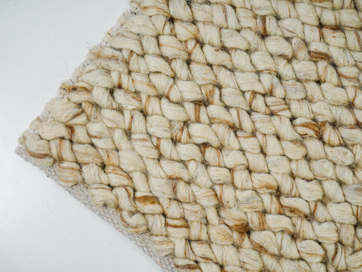 Beige Cashew Loop — Wool rug, angled corner showing rounded loops and the finished edge