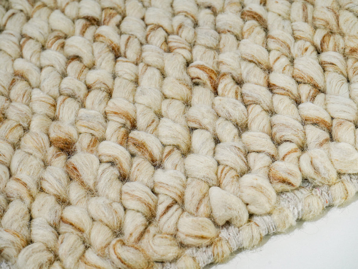 Cashew Loop — close-up of the weave, pile and edge finish, showing beige loops with tan accents