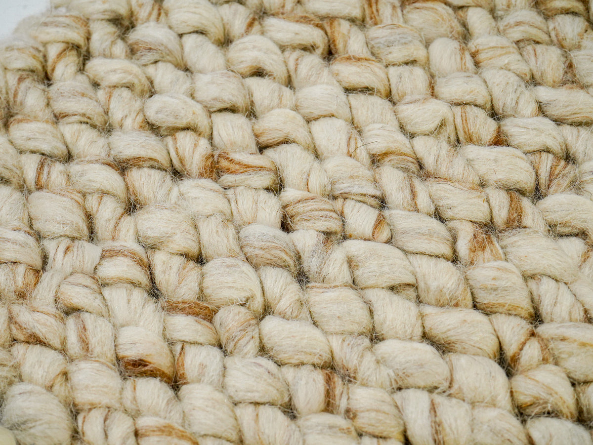 Cashew Loop — Wool rug, tight detail of rounded beige loops interspersed with tan strands