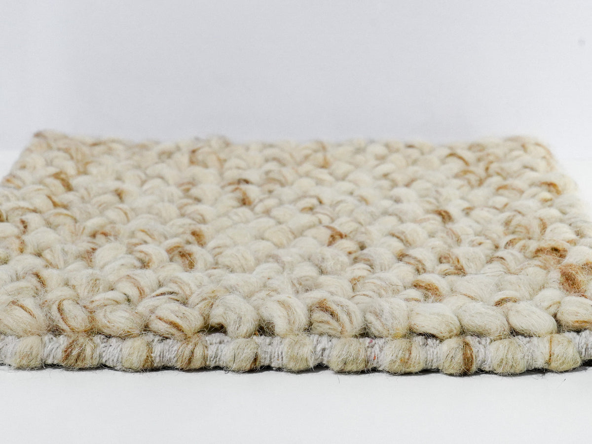 Beige Cashew Loop — Wool rug, low side profile showing the raised loop surface and bound edge