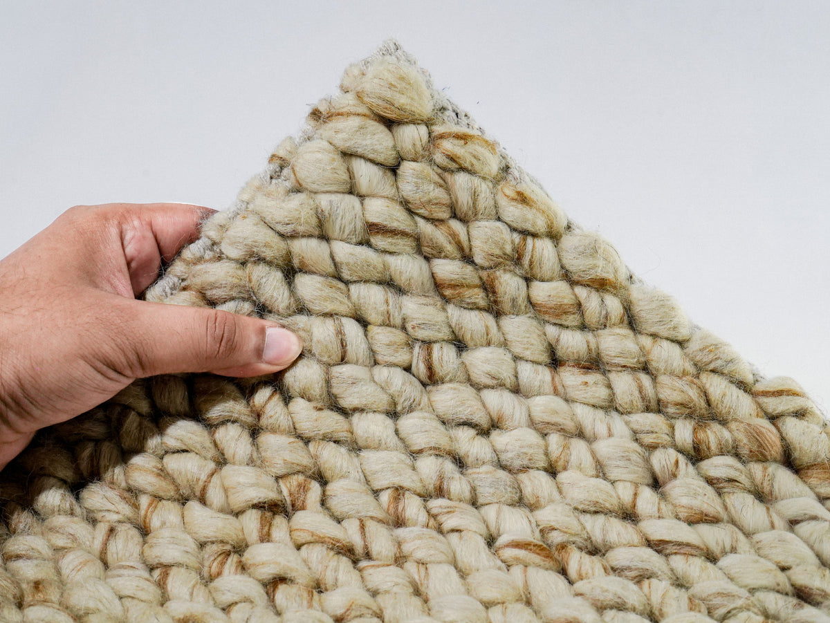 Cashew Loop — Wool rug styled in a living room, highlighting its beige and tan chunky texture