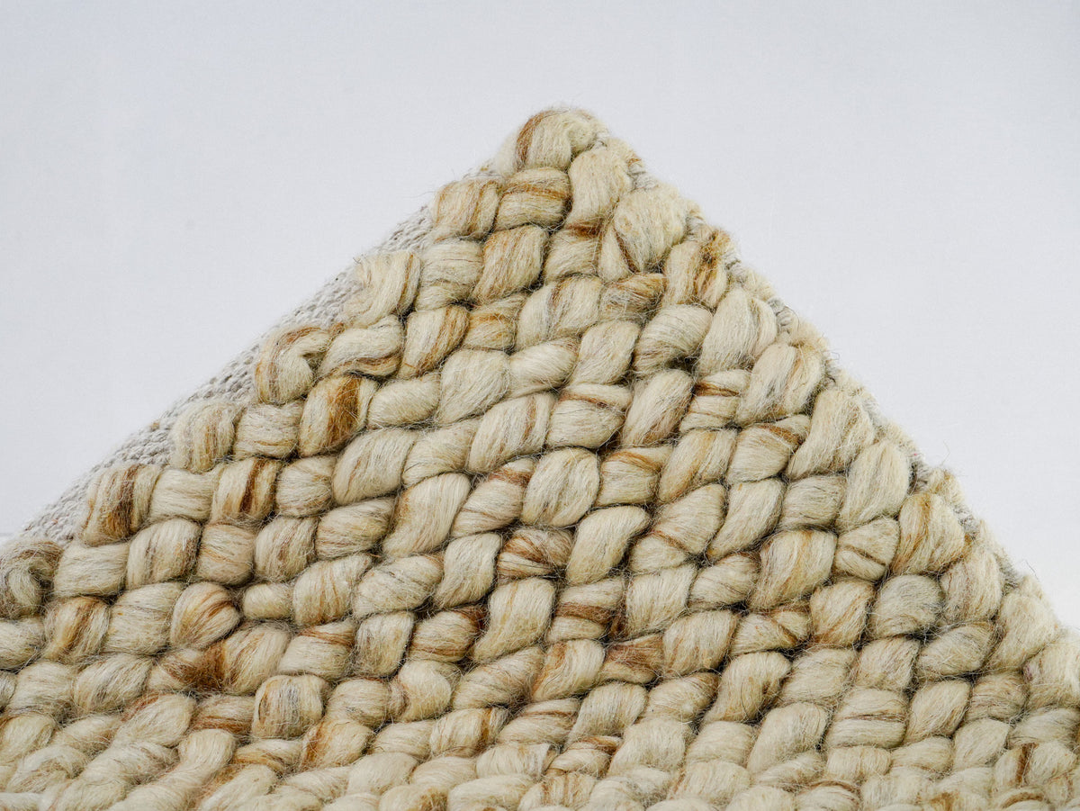 Cashew Loop — Wool rug, lifted front corner displaying diagonal rows of beige and tan loops