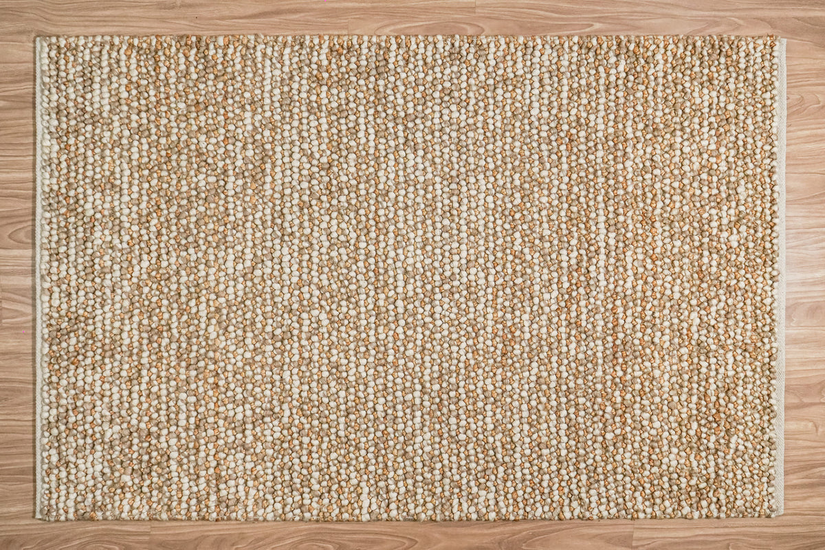 Loops With Jute — Beige Wool rug shown in full from overhead on a wood floor