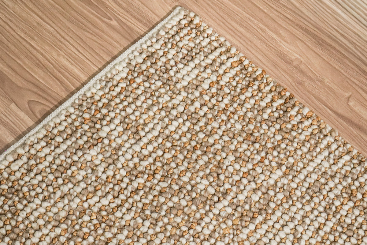Loops With Jute — Beige Wool rug with a corner pointing upward and rows of loops running diagonally across the image