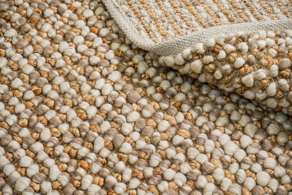 Loops With Jute — Beige Wool rug with a folded edge showing the loop surface, underside and binding together