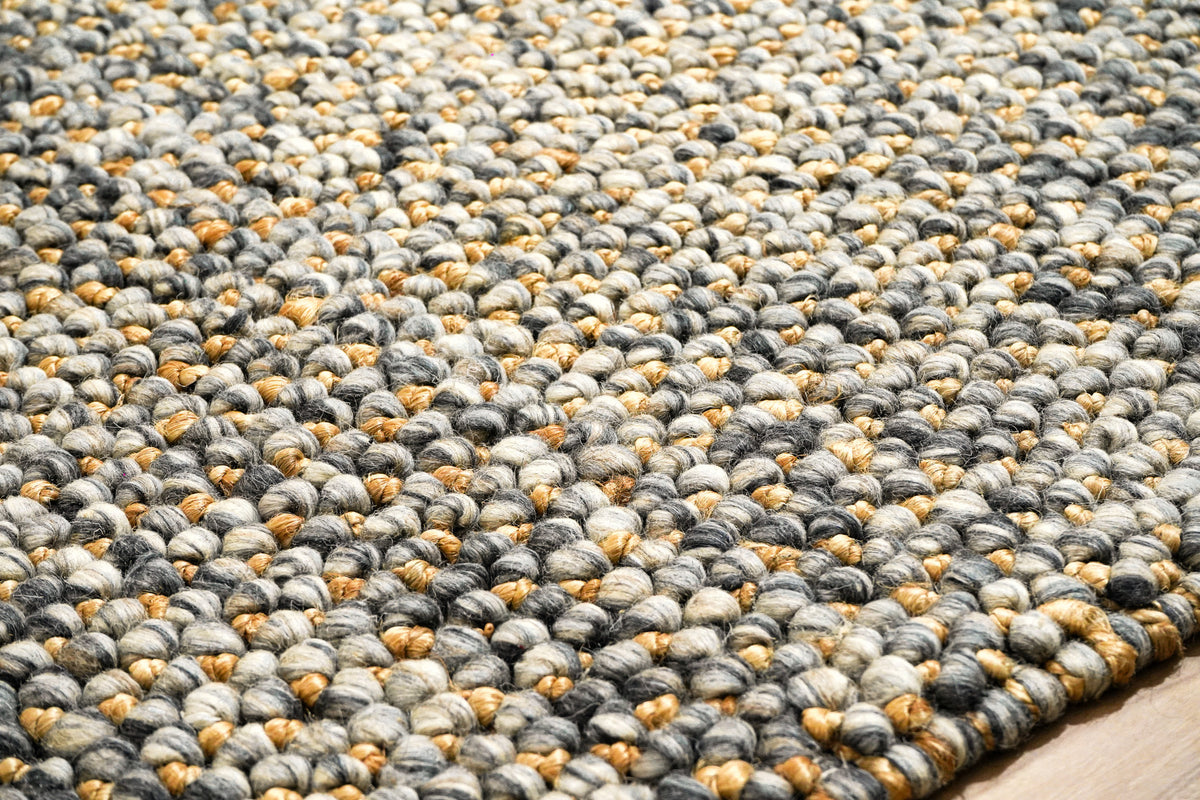 Loops With Jute — close-up of the weave, pile and edge finish, showing gray loops and golden-tan accents beside the floor