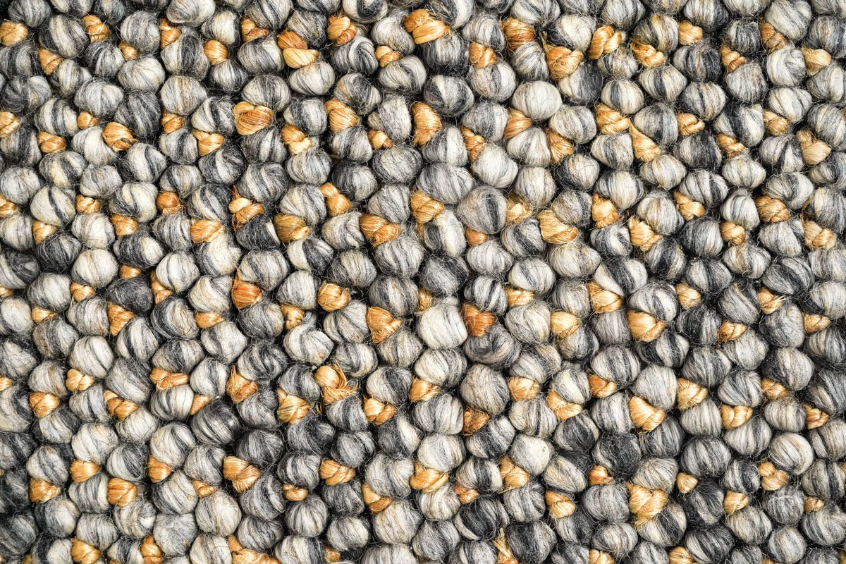 Loops With Jute — Gray Wool rug in an overhead macro view of pale and charcoal loops with golden-tan accents