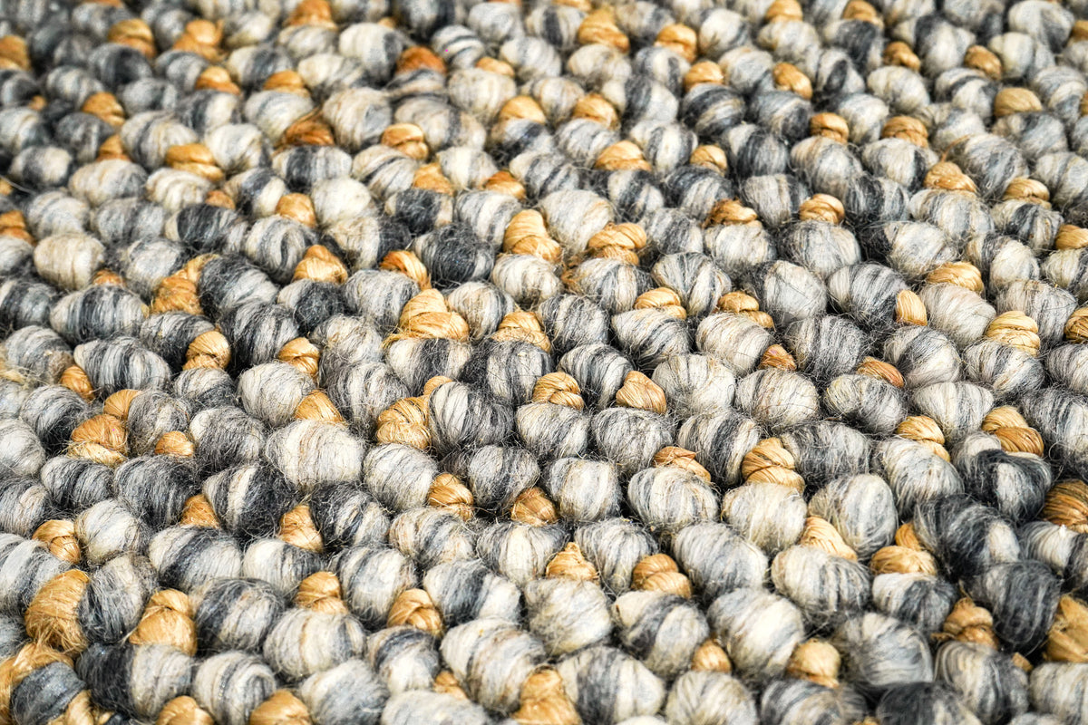 Loops With Jute — Gray Wool rug in an angled macro view showing individual rounded loops and visible fibers