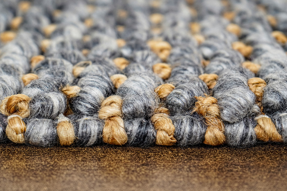Loops With Jute — low close-up across the gray wool rug's front edge and raised loops