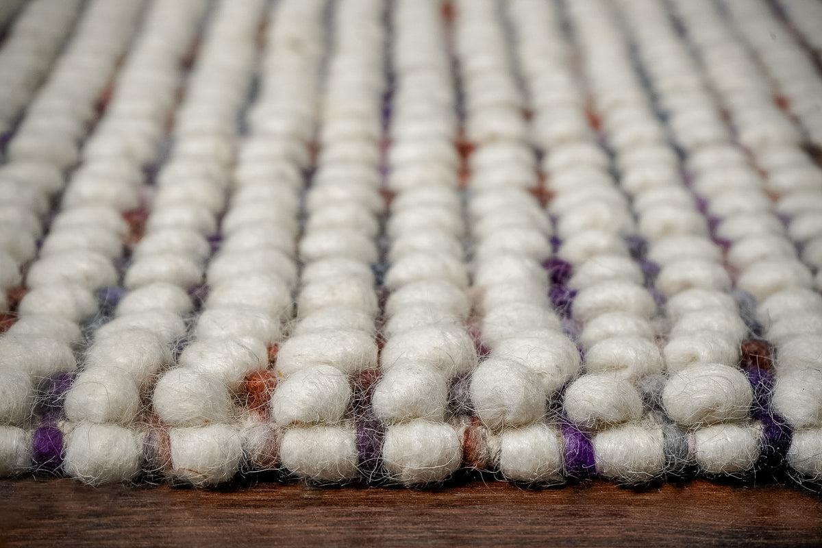 Alter Loops — Purple Wool rug in a low frontal close-up, with loop rows extending away from the edge