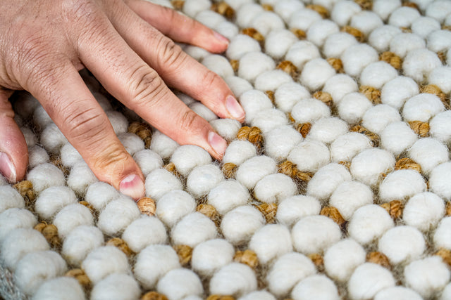 Loops With Jute — close-up of the ivory wool loops and jute weave filling the frame