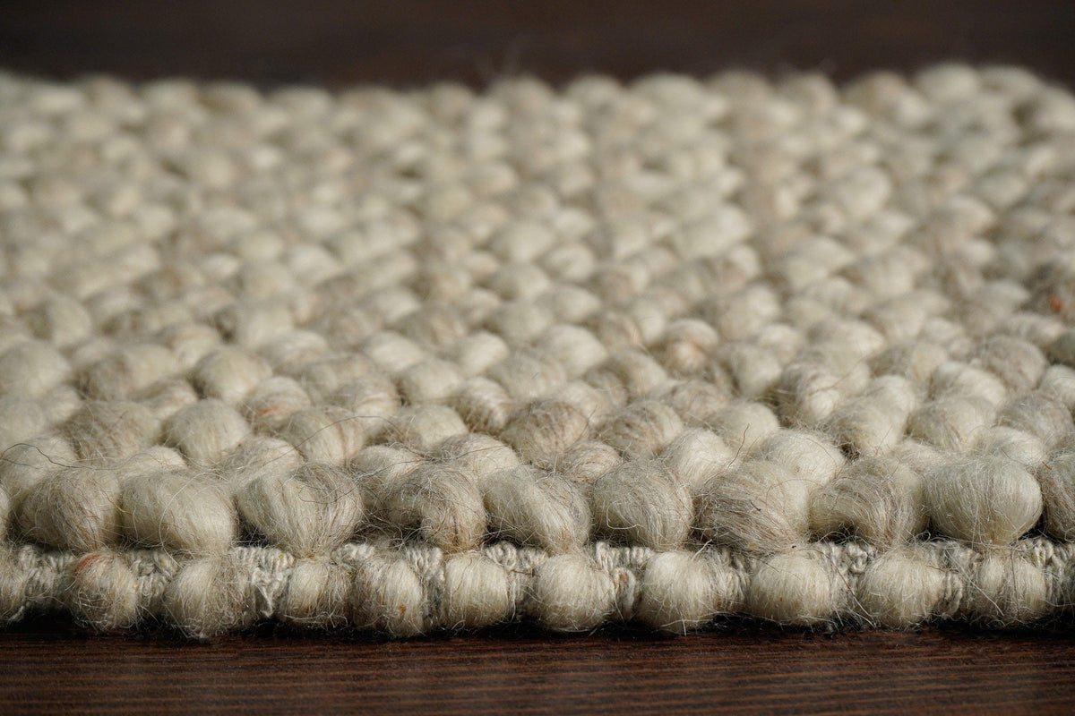 Beige chunky loop wool weave and edge detail — closeup 3