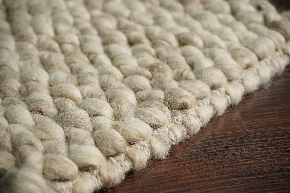 Beige chunky loop wool weave and edge detail — closeup 5
