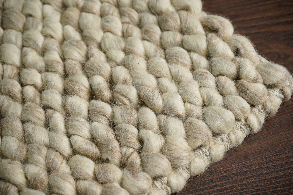 Beige chunky loop wool weave and edge detail — closeup 6