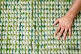 Cashew Loop — Green wool rug shown flat and in full on a plain white ground, detail crop of the centre (second pass)