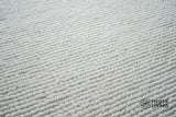 Detail of ivory wool rug edge finishing
