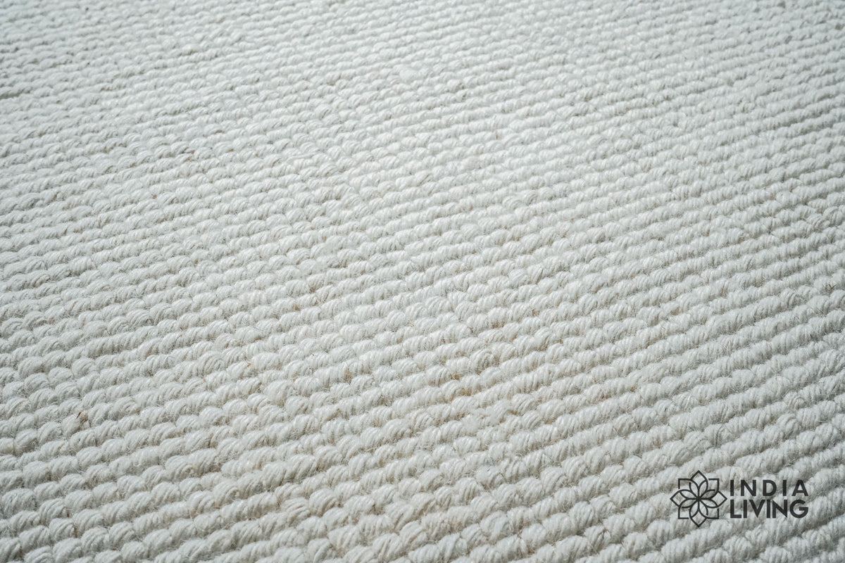Detail of ivory wool rug edge finishing