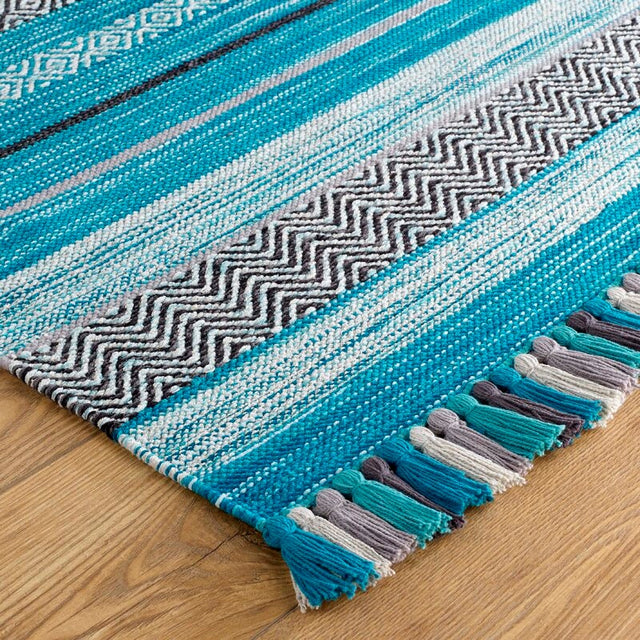 Teal blue kilim rug styled in living room
