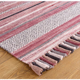 Pink striped dhurrie rug styled in a living room