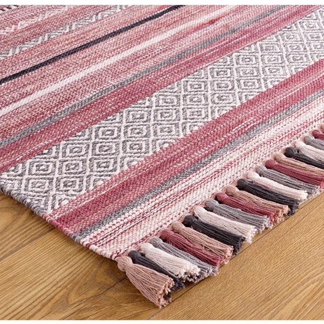 Pink striped dhurrie rug styled in a living room