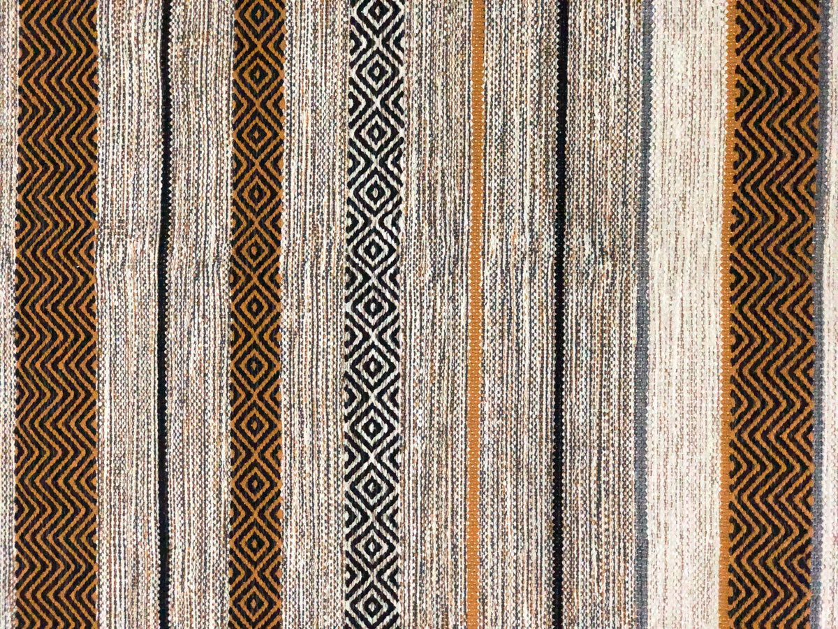 Ivory kilim rug styled in a bedroom setting