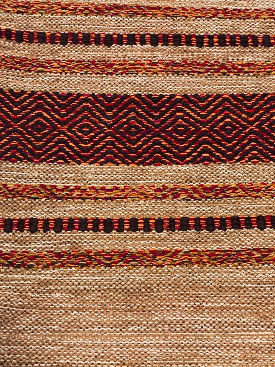 Beige cotton kilim rug in bedroom setting