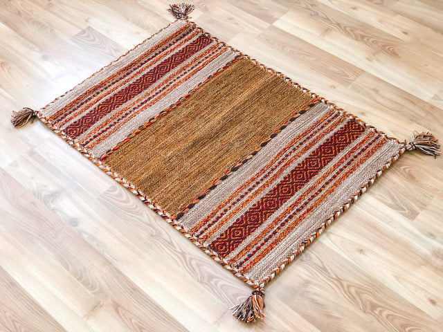 Beige cotton kilim rug styled in living room
