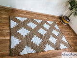 Diamond pattern jute rug styled in a coastal living room