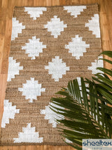 Diamond pattern jute rug in a bohemian bedroom setting