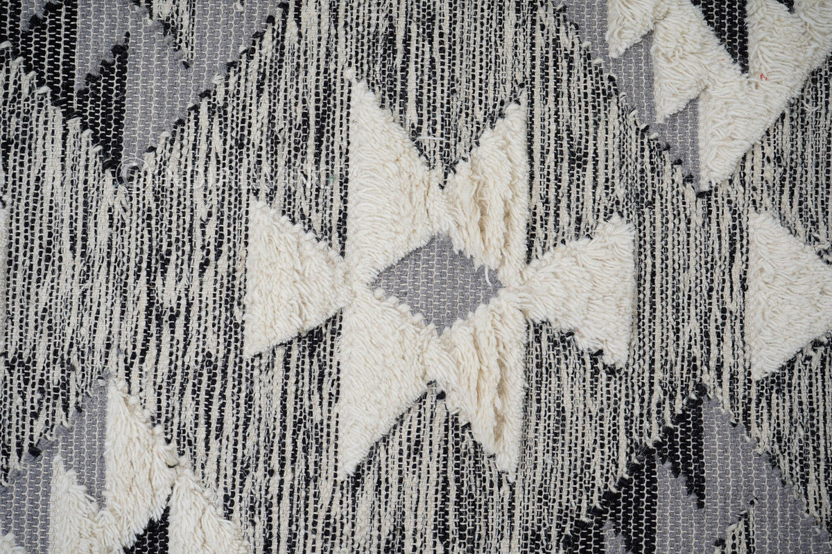 Grey wool rug in a bedroom setting