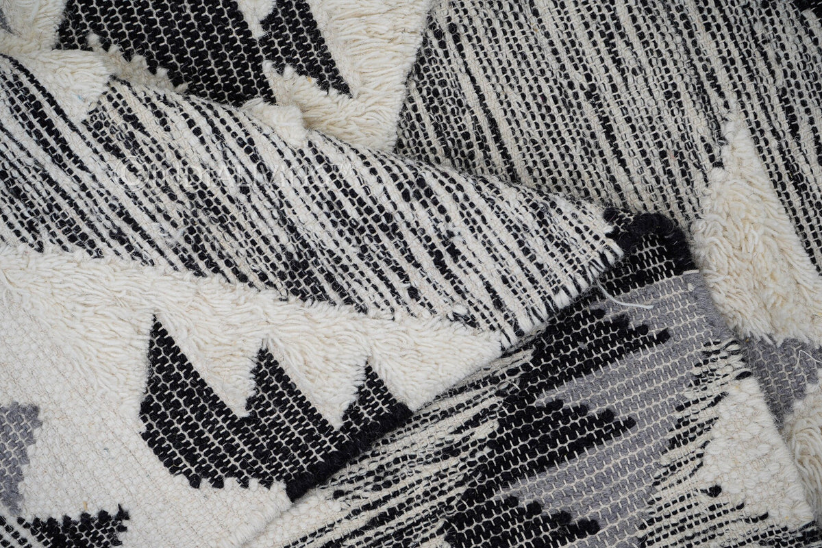 Grey wool rug fringe detail close-up