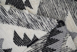 Grey wool rug fringe detail close-up