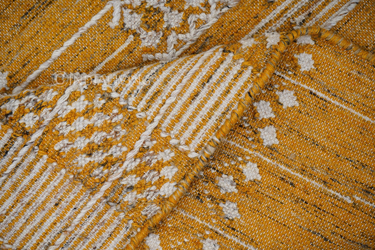 Yellow rug fringe and braided edge detail
