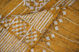 Yellow rug fringe and braided edge detail