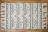 Close-up of handwoven texture on pink blue rug