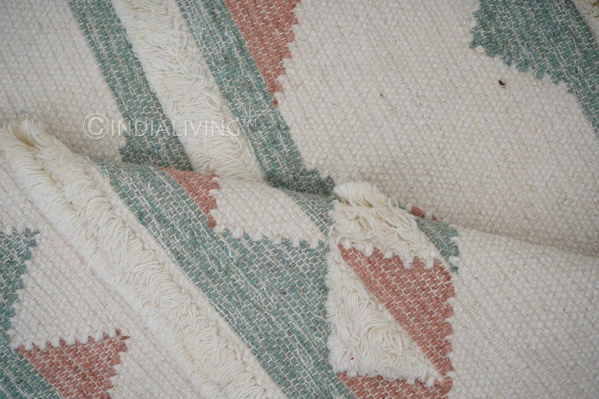Pink blue kilim rug styled in a bedroom setting