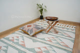 Bohemian pink blue rug styled with abstract patterns