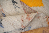 Close-up of handwoven texture on beige abstract rug