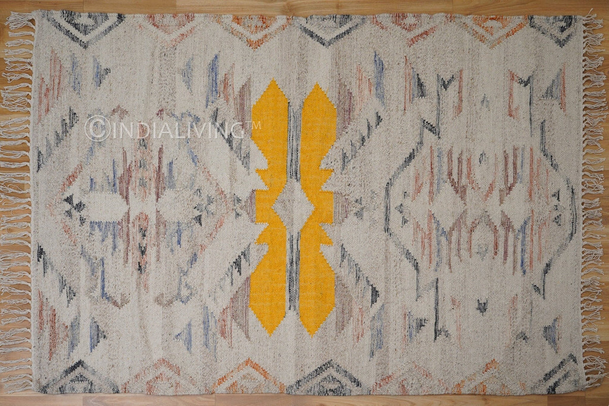Beige abstract kilim rug under a coffee table