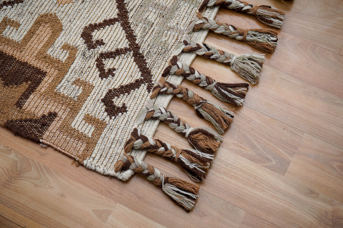 Close-up of handwoven texture on brown beige rug
