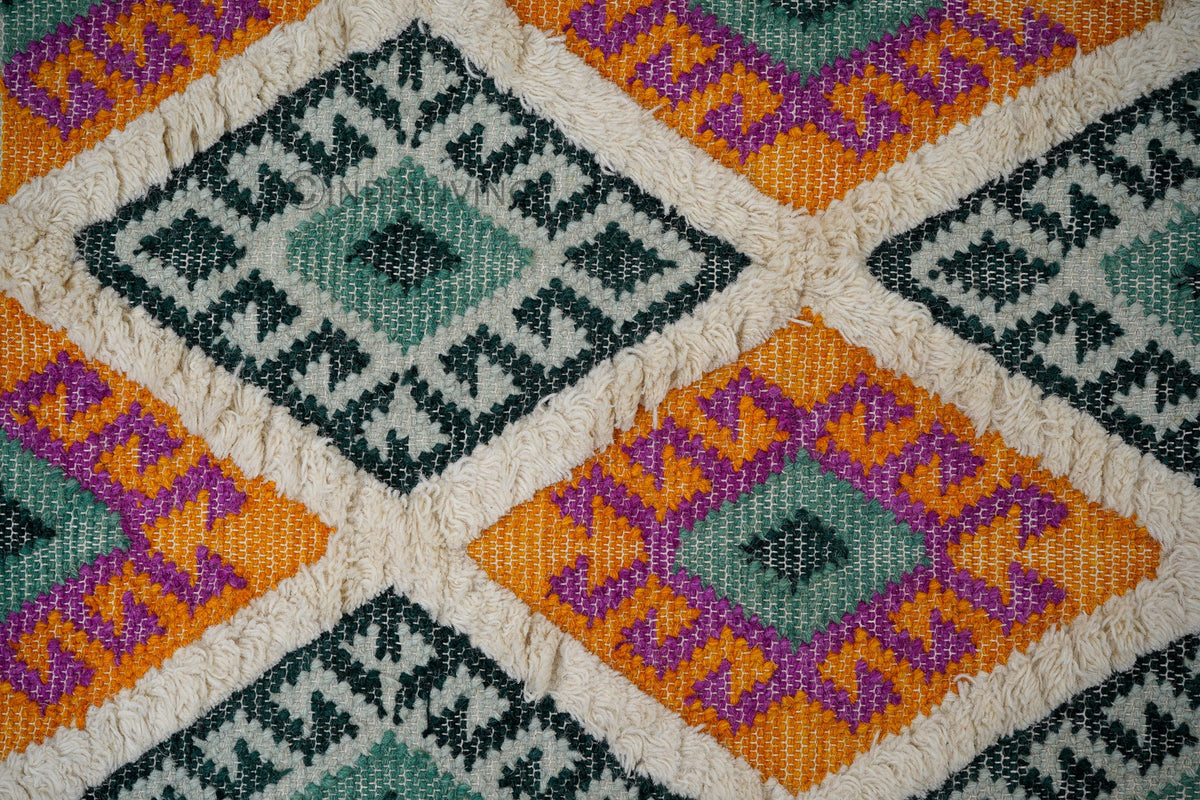 Green rug edge and fringe close-up detail