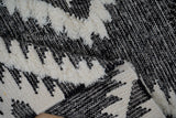 Black rug corner detail with fringe edge