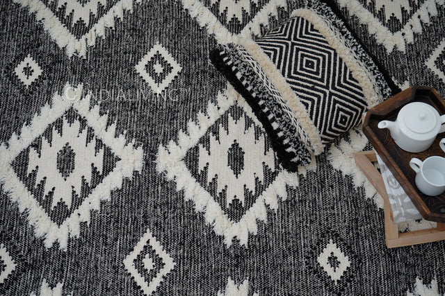 Handwoven black Moroccan Berber wool rug, flat lay view